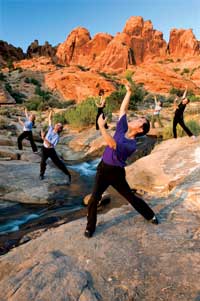 Photo of Li Jun Fen and class in an outdoor setting by a creek